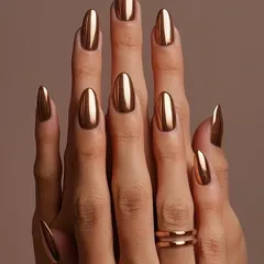 They call me the 'queen of bling' for a reason. This full set of almond-shaped chrome nails in a brilliant liquid gold finish is the ultimate statement in luxury. It's a bold, high-impact look that I love creating for clients who aren't afraid to stand out.