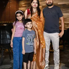 A classic portrait of a family of four at a restaurant celebration. I make sure to get these essential group shots.