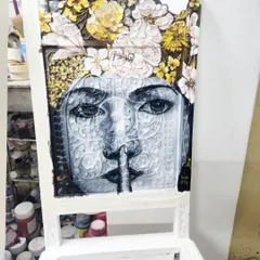 We turned a simple chair into a piece of functional art. This is an in-progress shot of a hand-painted portrait, featuring a woman crowned with yellow and white flowers, showcasing our ability to add intricate, artistic detail to everyday furniture.