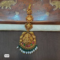 This traditional maang tikka is crafted from hallmarked 92.5 silver and plated in gold for a rich, authentic look. The centerpiece features a beautifully detailed Goddess Lakshmi motif, perfect for bridal and temple jewelry collections.