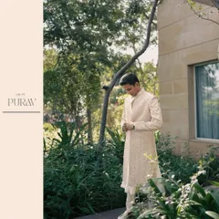 A stylish portrait of the groom, getting ready in a garden setting, capturing a moment of quiet anticipation before the celebrations begin.
