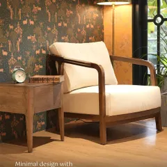 A complete reading nook featuring my handcrafted armchair and a matching side table. The piece is set against a whimsical wallpaper, demonstrating how my furniture can complement diverse interior styles.