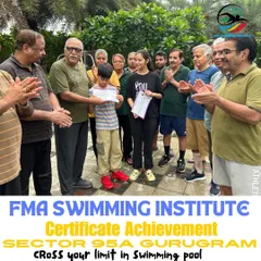 A young swimmer receives his achievement certificate, surrounded by applause from our senior members. This shows the supportive, cross-generational community we've built at FMA.