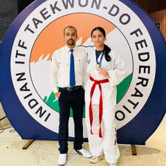 I am incredibly proud to stand with my student after her win at the Indian ITF Taekwon-Do Federation championship. My goal is to prepare athletes for real competition, pushing them to achieve their best.