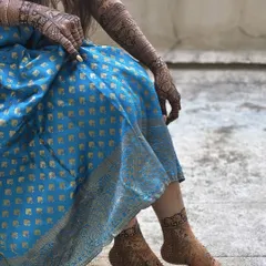 A candid shot showing the beautiful stain of both the hand and feet mehendi. A complete bridal look from head to toe.