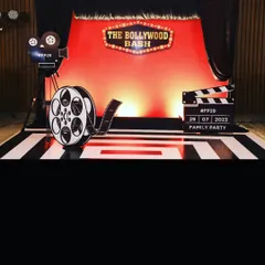 Lights, camera, action! A 'Bollywood Bash' themed photo booth, complete with a film reel, a director's clapperboard, and a vintage camera prop. The red carpet vibe was a huge hit with guests.
