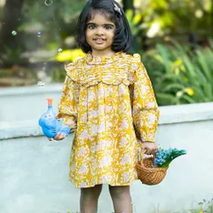 A little girl enjoying a sunny day in the garden, surrounded by wildflowers and bubbles. Outdoor sessions are perfect for capturing this kind of carefree happiness.