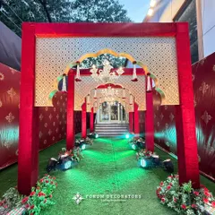 For a truly grand and royal statement, I designed this opulent red and gold entrance. The layered arches with traditional motifs, velvet textures, and brilliant chandeliers create an unforgettable first impression for a regal shaadi.