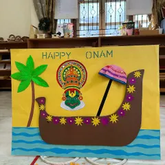 Our Onam celebration board, featuring a handcrafted Kathakali mask and a traditional snake boat, setting the stage for the festivities.
