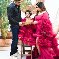 A complete family moment captured in the studio. The father, mother, and daughter all interact, celebrating the new life that will soon join them.