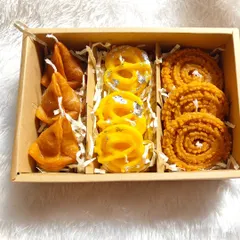 Another one of my Indian sweet-themed candle boxes. This one contains candles shaped like samosas, jalebis, and chaklis, all handmade from soy wax.