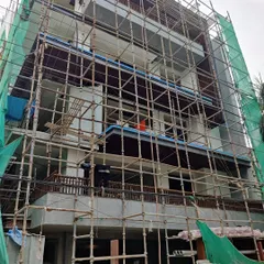 A residential building in the middle of its facade transformation. The entire structure is covered in scaffolding as our team works on applying new finishes and architectural elements. It's starting to shape up into a beauty.
