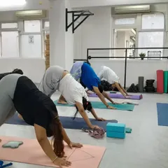 The large mirrors are a key feature, allowing participants to check their form, as seen in this Downward-Facing Dog pose. This is especially useful for dance workshops, fitness training, and detailed yoga instruction.