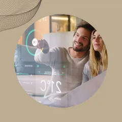 We design wired automation systems that are both powerful and easy to use. A couple interacts with a transparent smart home display, showcasing the futuristic yet accessible control that a KNX system provides.