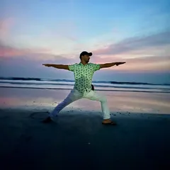 Holding Virabhadrasana II (Warrior II) as the sun sets over the ocean. In moments like these, the division between self and nature dissolves, and the practice becomes a prayer of gratitude.