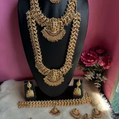 This is one of our most loved South Indian temple jewellery sets, perfect for a traditional bridal look. The complete set includes a choker, a long haram, matching jhumkas, a maang tikka, and other accessories to make you feel like a goddess.