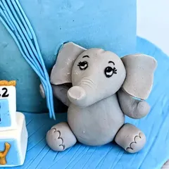This cute, hand-sculpted baby elephant was the star of a welcome cake for a baby prince. I focus on creating sweet, expressive faces and clean details to bring these little fondant animals to life.