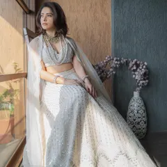I styled Nushrratt Bharuccha in this ethereal ivory lehenga by Disha Patil for a wedding. The layered pearl necklaces add a touch of modern royalty, making it a standout look for a wedding guest.