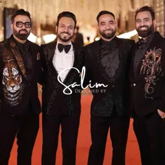A group of friends celebrating in style, each wearing a custom piece. The designs range from a hand-painted tiger jacket to a sequined tuxedo and an embroidered dragon motif, showing the variety of my statement wear.