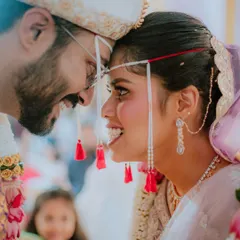 An intimate close-up capturing the laughter and connection between the bride and groom during their Maharashtrian wedding ceremony. These are the unscripted moments that make your story unique.