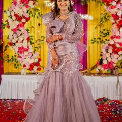 A full-length view of the lavender fish-cut gown, showing how the silhouette flatters the figure while the tiered net skirt adds drama and movement.