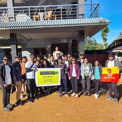 Our Kumara Parvatha batch, holding our banner and the Kannada flag, ready to start the trek from the homestay.