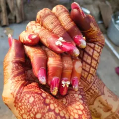 A classic bridal look perfect for the big day. I used gel extensions to create this elegant shape, combining a bold red gel polish with gold glitter accents and delicate 3D bows. This is the kind of glamorous wedding nail art I love creating for my brides.