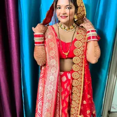 A radiant bride in her red wedding attire. Her hands, adorned with my intricate mehndi, complete her traditional and beautiful look.