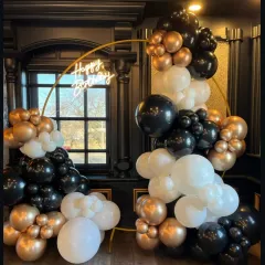 A sophisticated black, white, and bronze gold balloon arrangement on a circular frame. This elegant design with a neon sign is perfect for upscale birthday parties or corporate events.
