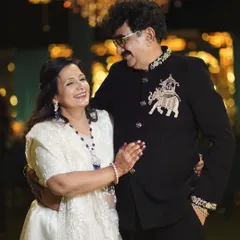 A client radiating joy in a custom black Bandhgala. The jacket is highlighted by a stunning, hand-embroidered elephant motif on the chest, showcasing how my bespoke designs add a touch of personal history and elegance to any occasion.