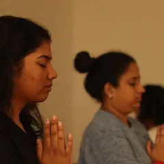 A close up of students in a moment of quiet reflection during a sound healing session. This practice can be profoundly relaxing and centering.