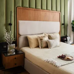 A bedroom that whispers serenity. We curated this space to feel like a warm embrace, using soft hues, warm light, and the quiet companionship of greenery to ensure mornings feel lighter and evenings feel calmer.