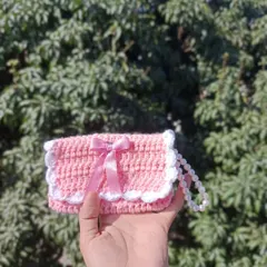 A sweet pink pocket purse with a white scalloped edge and a satin bow. This design is very popular for event giveaways and college fests.