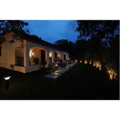 The right lighting can completely transform an outdoor space after sunset. Here, I used a combination of subtle uplighting on the trees and warm, welcoming lights along the pathway and within the verandas. This strategic landscape lighting design enhances the building's classic architecture and creates a safe, magical ambiance for evening enjoyment.