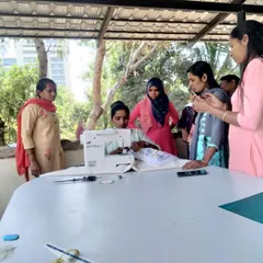 Our instructor provides personalized guidance on using a sewing machine during a beginner class, ensuring every student feels confident.