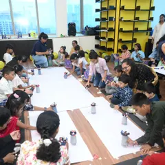 A room full of focused, happy inventors. We set up fully managed activity zones where dozens of children can simultaneously build their own robots, ensuring every child is engaged and has a personal creation to take home.