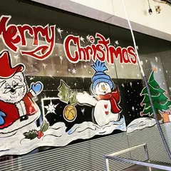 Getting a shop ready for the holidays with a cheerful Christmas scene. This temporary window painting features Santa Claus and a snowman, perfect for attracting customers and spreading festive cheer.