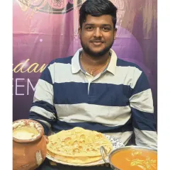 A complete meal featuring our famous Matka Chicken, served in a traditional clay pot, alongside soft parathas and cool raita.