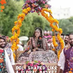 A creative bridal entry idea with the bride carried in on a doli shaped like a floral basket, decorated with marigolds.
