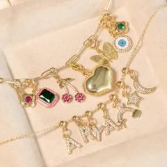 Customize your favorite necklace. This image shows a variety of charm options, including initial letters, butterflies, and gemstones, that you can add to my link chain necklaces.