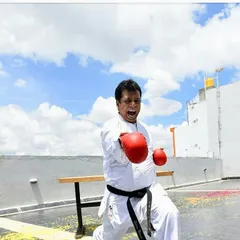 The spirit of karate is captured in this moment of intense focus and power. Hanshi Sir demonstrates a gyaku zuki, or reverse punch, with a powerful kiai.