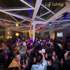 A wide shot of a packed rooftop party at Shangri-la, Bangalore. I specialize in curating sundowner sets that build into high-energy nights.