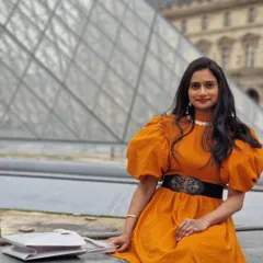 Another lovely shot of our client in Paris. The bold color of the dress, paired with the dramatic sleeves and a statement belt, creates a memorable and fashionable travel look.