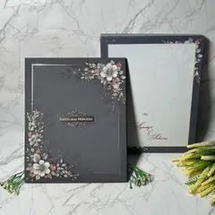 I love the drama of a dark, moody palette. This luxurious invitation suite pairs a sophisticated charcoal background with soft floral illustrations and elegant typography, creating a bold and unforgettable first impression.