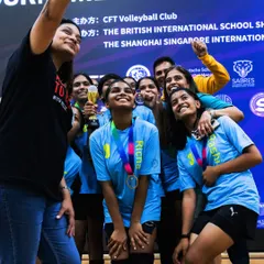 A selfie to capture the pure joy of victory. Holding the championship trophy with the team is a memory we will cherish forever.