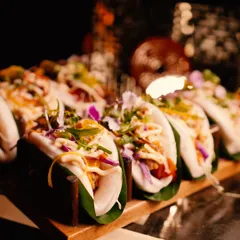Fluffy steamed bao buns filled with delicious, savoury fillings and fresh garnishes. A modern Asian street food classic, elevated for a luxury experience.