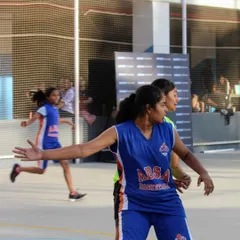 An athlete in our girls' program positions herself on defense, communicating with her teammates. We foster a team-first mentality where every player understands their role and contributes to the group's success.