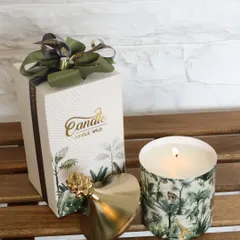 Our Jungle Wild scented candle, featuring a lush print and a chic gold pineapple lid. It comes beautifully packaged, making it a perfect tropical-inspired gift.