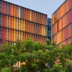 For the Infosys Campus in Nagpur, we designed a dynamic facade with colourful fins that are not merely aesthetic. Each fin is precisely angled to provide solar shading, reducing heat gain and glare, which significantly lowers the building's reliance on air conditioning and creates comfortable, naturally lit workspaces.