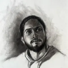 A finished live portrait done with charcoal on paper. My goal is to capture a moment and an expression, using shading and contrast to bring out the subject's character. This is a quick and honest form of art.